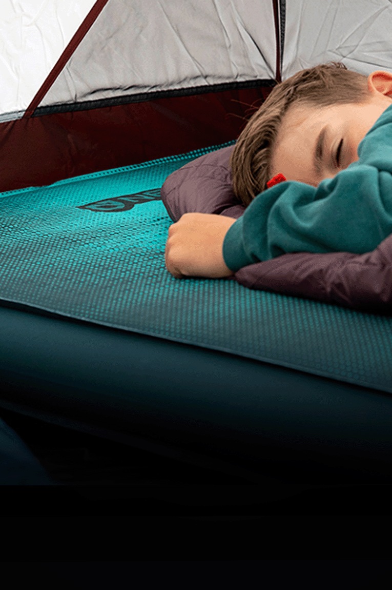 A camper rests on the NEMO Roamer Sleeping Pad