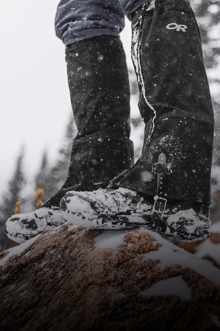 A hiker wears the Outdoor Research Crocodile GORE-TEX gaiters on a snowy trail