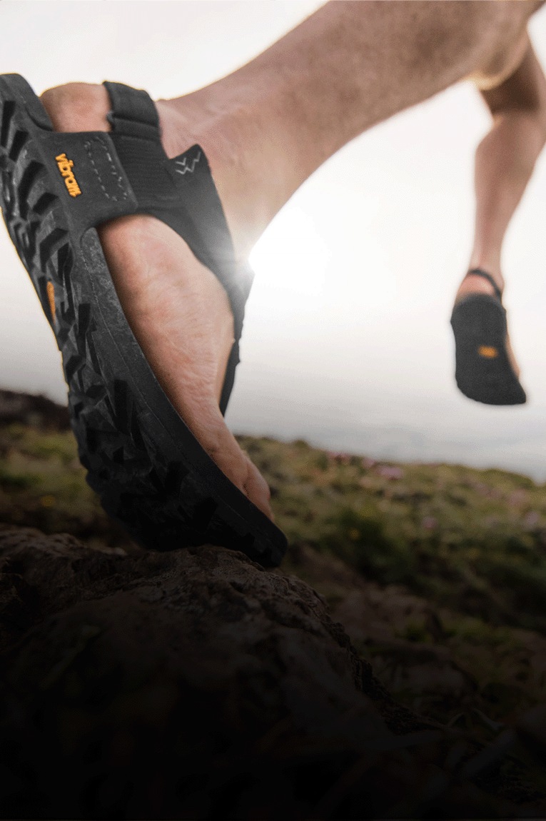 Two people on a trail wearing Bedrock sandals