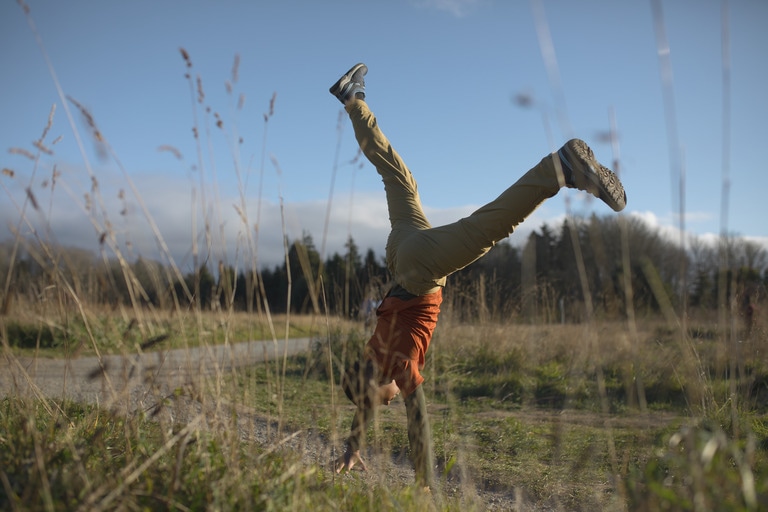 Man does cartwheel among the grasses