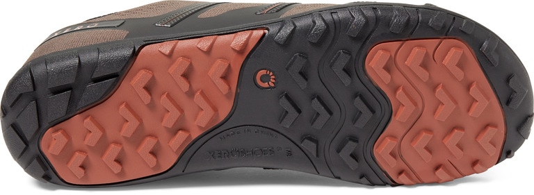 A zero-drop minimalist hiking shoe shown laying on its side with its outsole exposed.