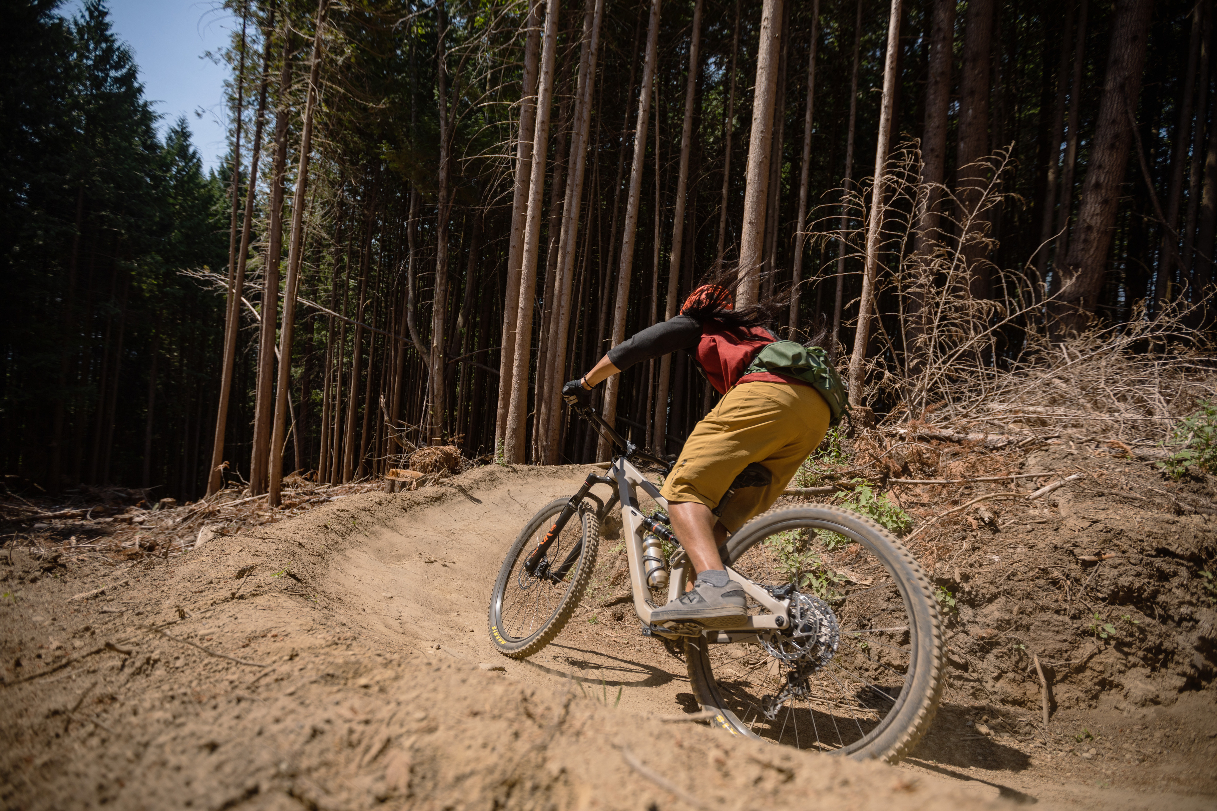 A mountain biker speeds up a dirt trail.
