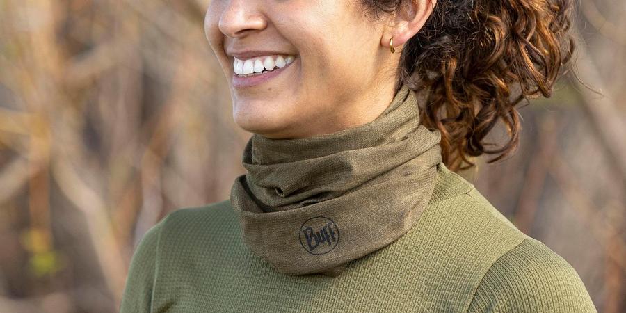 A person wearing Buff Lightweight Merino Wool Multifunctional Headwear on their neck