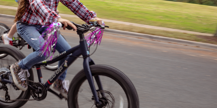 a child rides a blue bike with gears