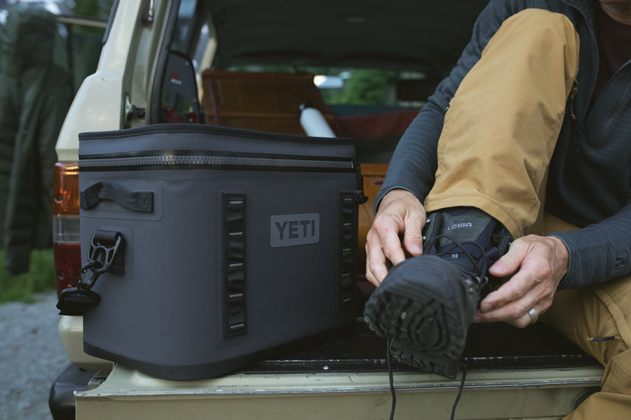 Image of a black YETI Hopper Flip 12 Soft Cooler in the back of a vehicle