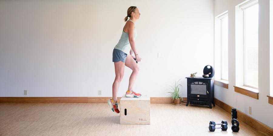 A woman performs a single-leg step up onto a 16-inch box