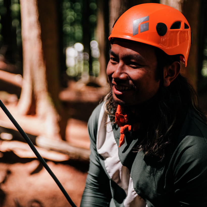 climbing guide giving instructions to a group of participants
