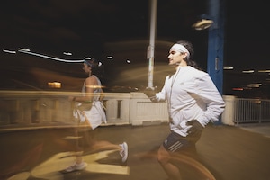 Blurry image as a man and woman run at night