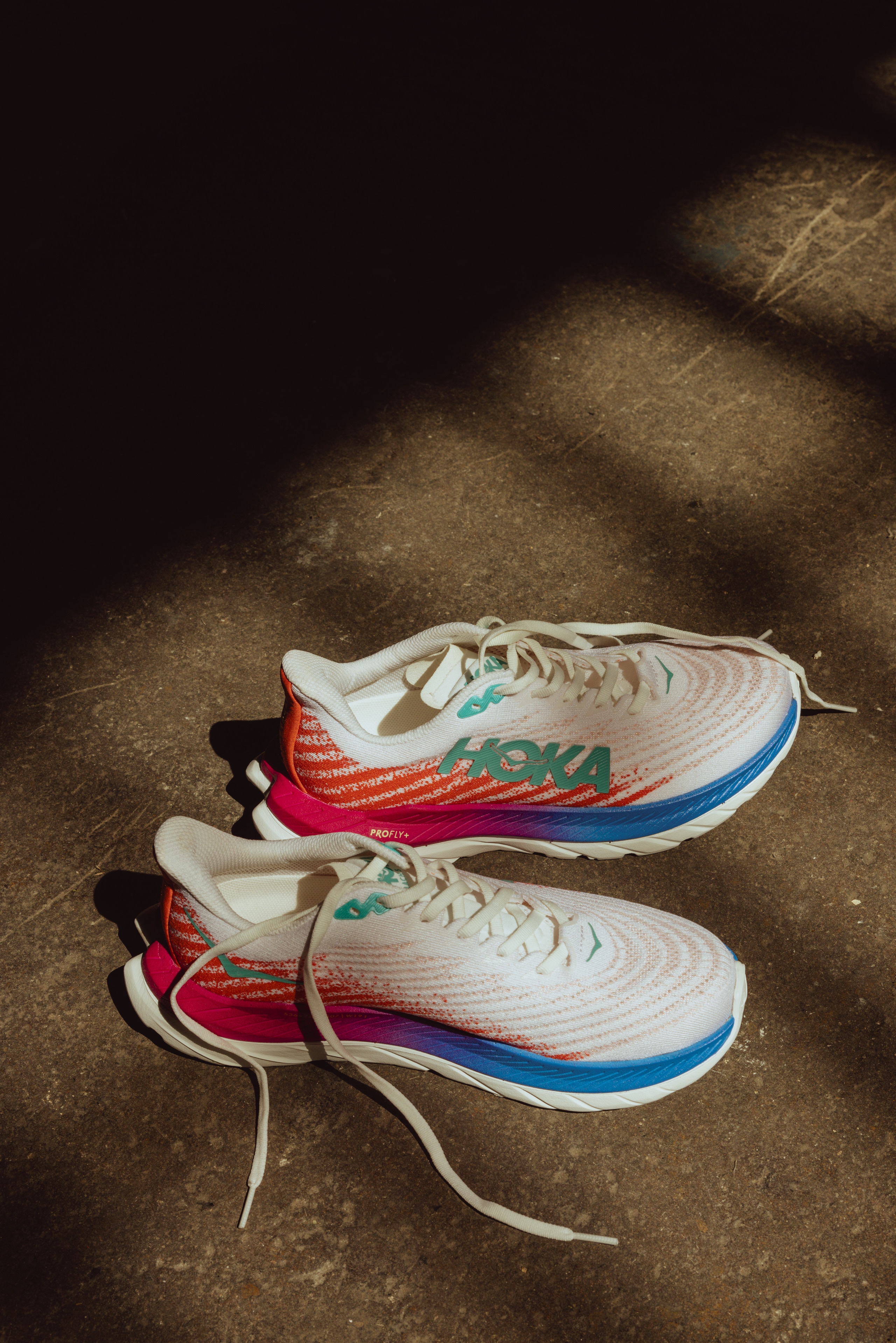 Road running shoe by HOKA with a white upper