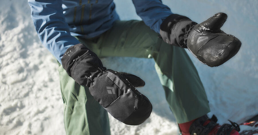 A snowboarder wears Black Diamond Mercury mittens.