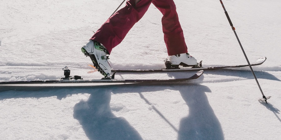 A person skiing with alpine touring bindings