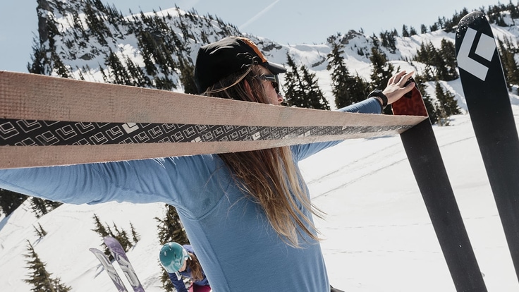 Person peeling skins off of a ski