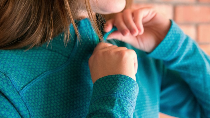 zipping up a base layer top