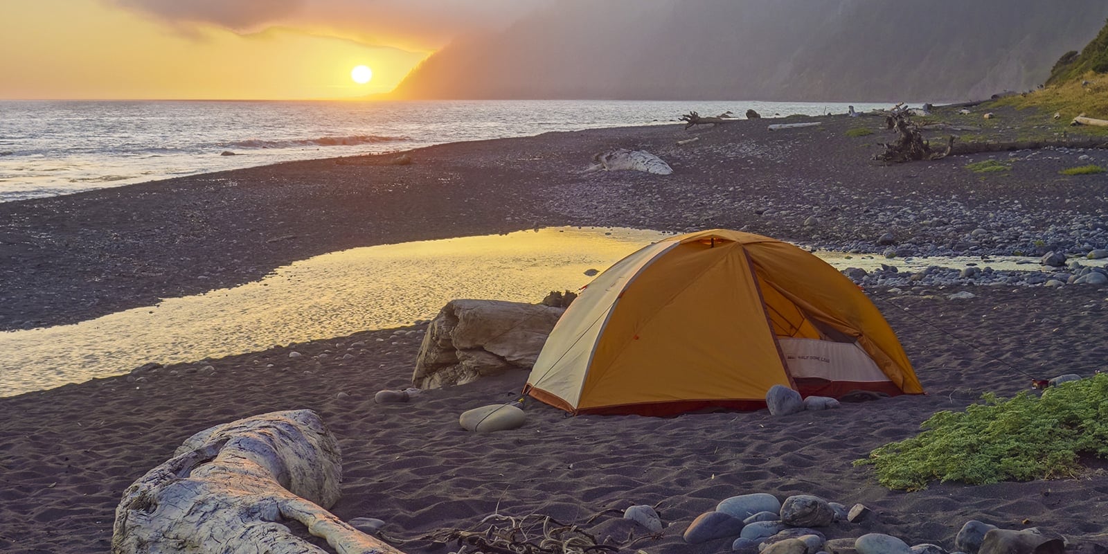 tent on beach at sunset