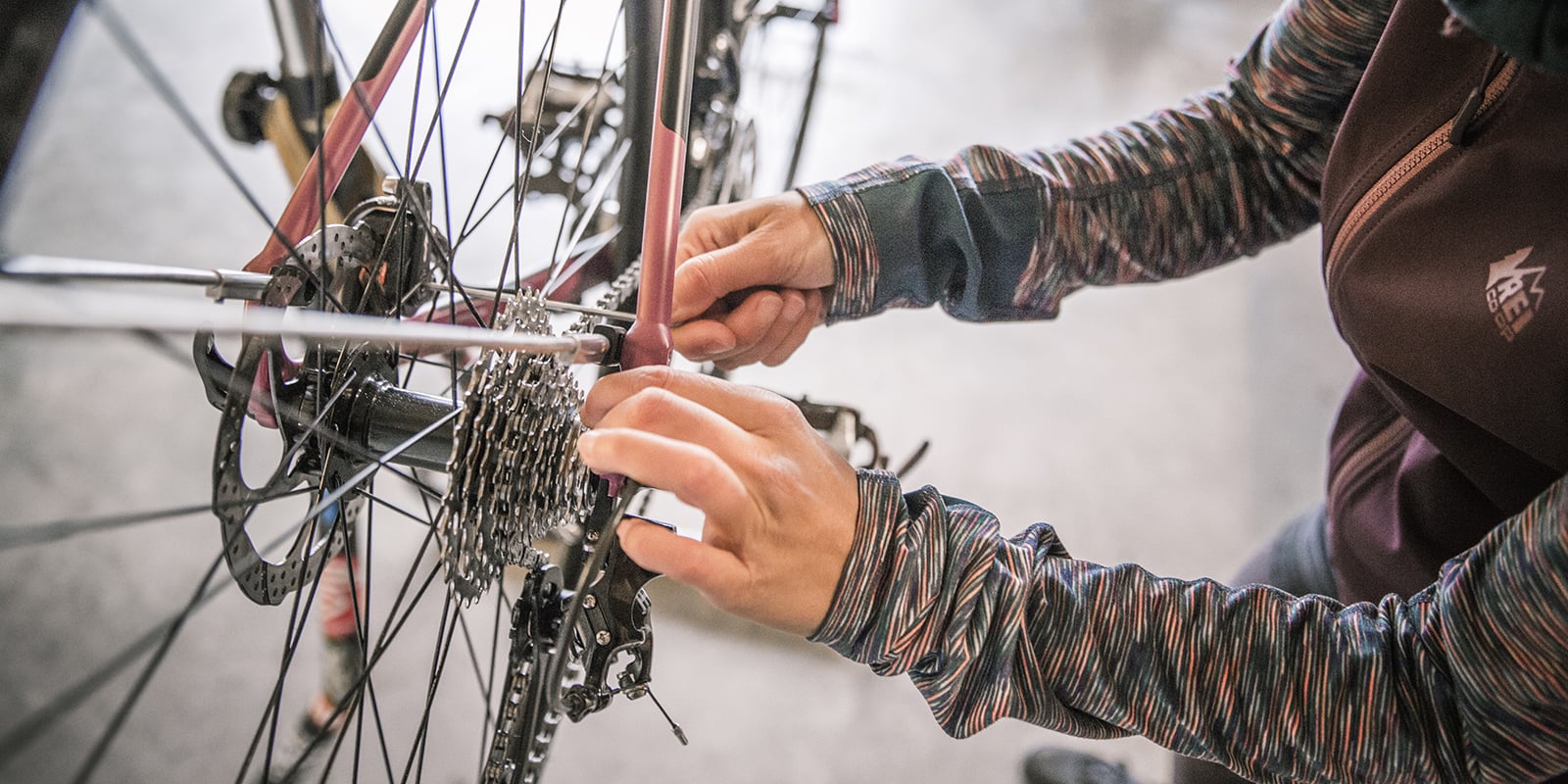 a cyclist performing maintenance on their bike