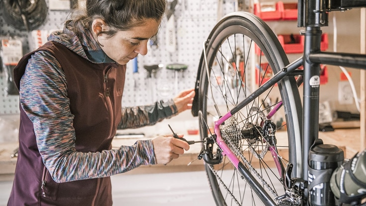 a cyclist performing maintenance on their bike