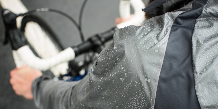 Water beads up on the rain jacket of a cyclist