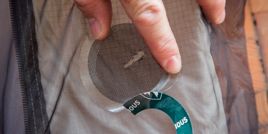 Application of a patch on the mesh part of a tent