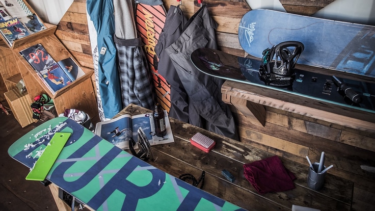 A snowboard being waxed in a snowboard shop