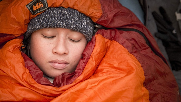 camper bundled up in sleeping bag