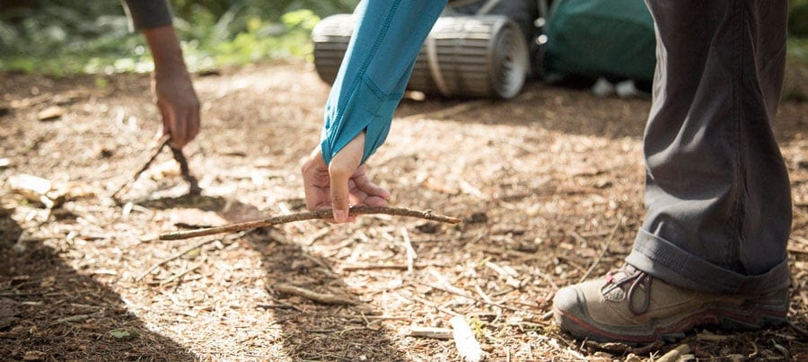 campers clearing debris from their campsite