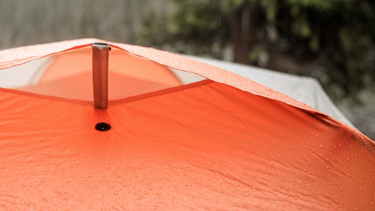 water beading off of a waterproof tent in the rain