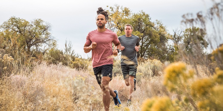 Two trail runners in a field