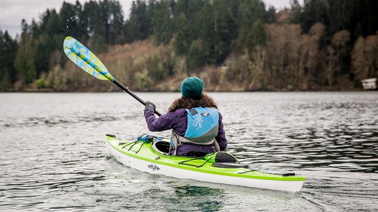A kayaker sets out on a crisp fall day