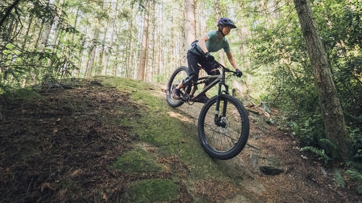a mountain biker riding down a hill