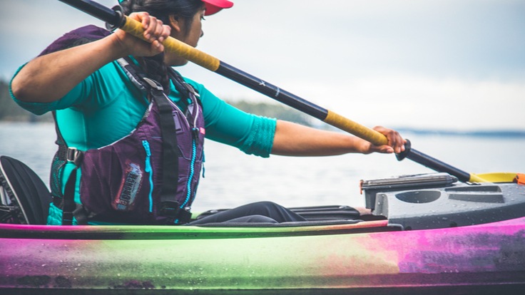 a kayaker with a strong paddle stroke