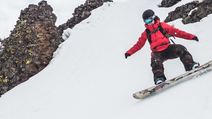a snowboarder carving a turn