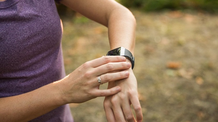 Runner looking at speed and distance monitor