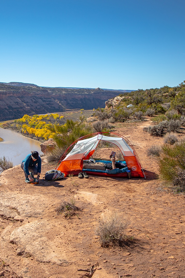 A camper sits in the Big Agnes Copper Spur HV UL Bikepack Tent.