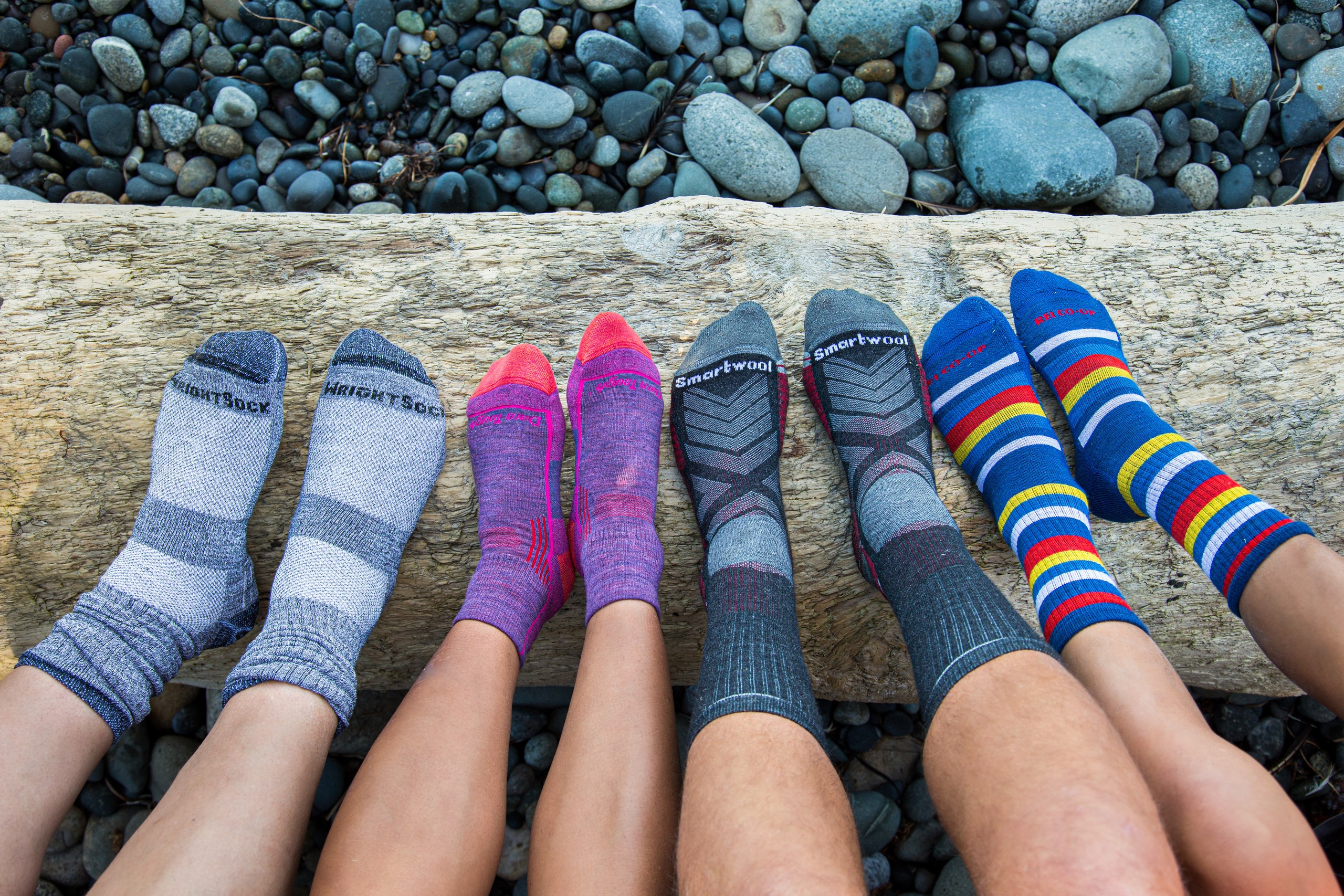 A collection of people lining their sock feet up in a row.