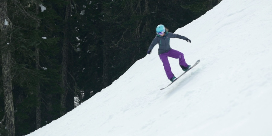 a snowboard in mid leap, while doing a leaper