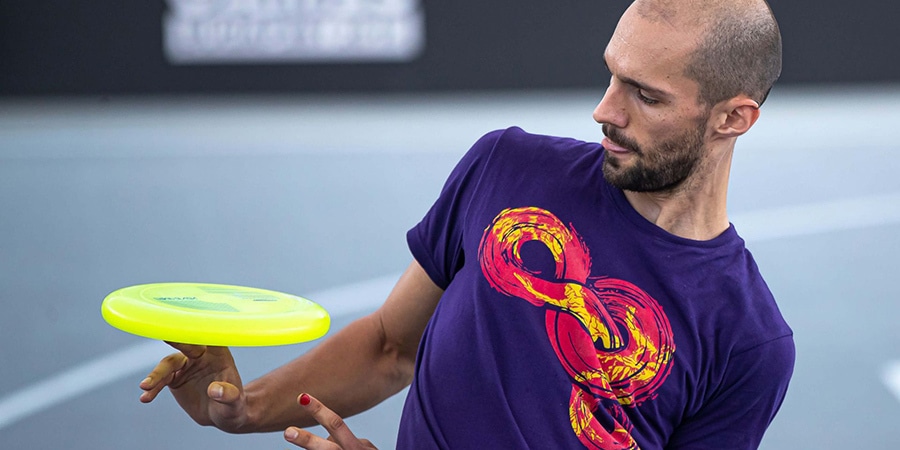 A person competing in a flying disc freestyle event