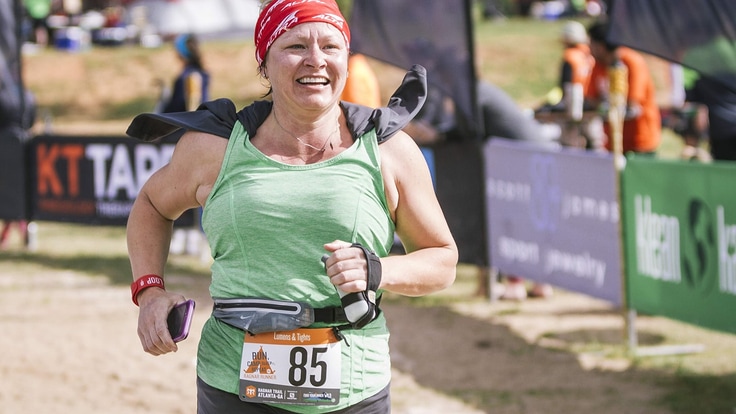 Woman smiling as she nears the finish line