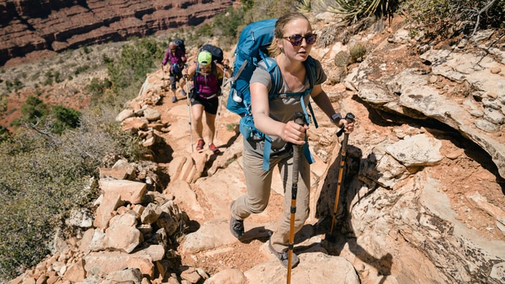 A group of backpackers hiking on steep terrain