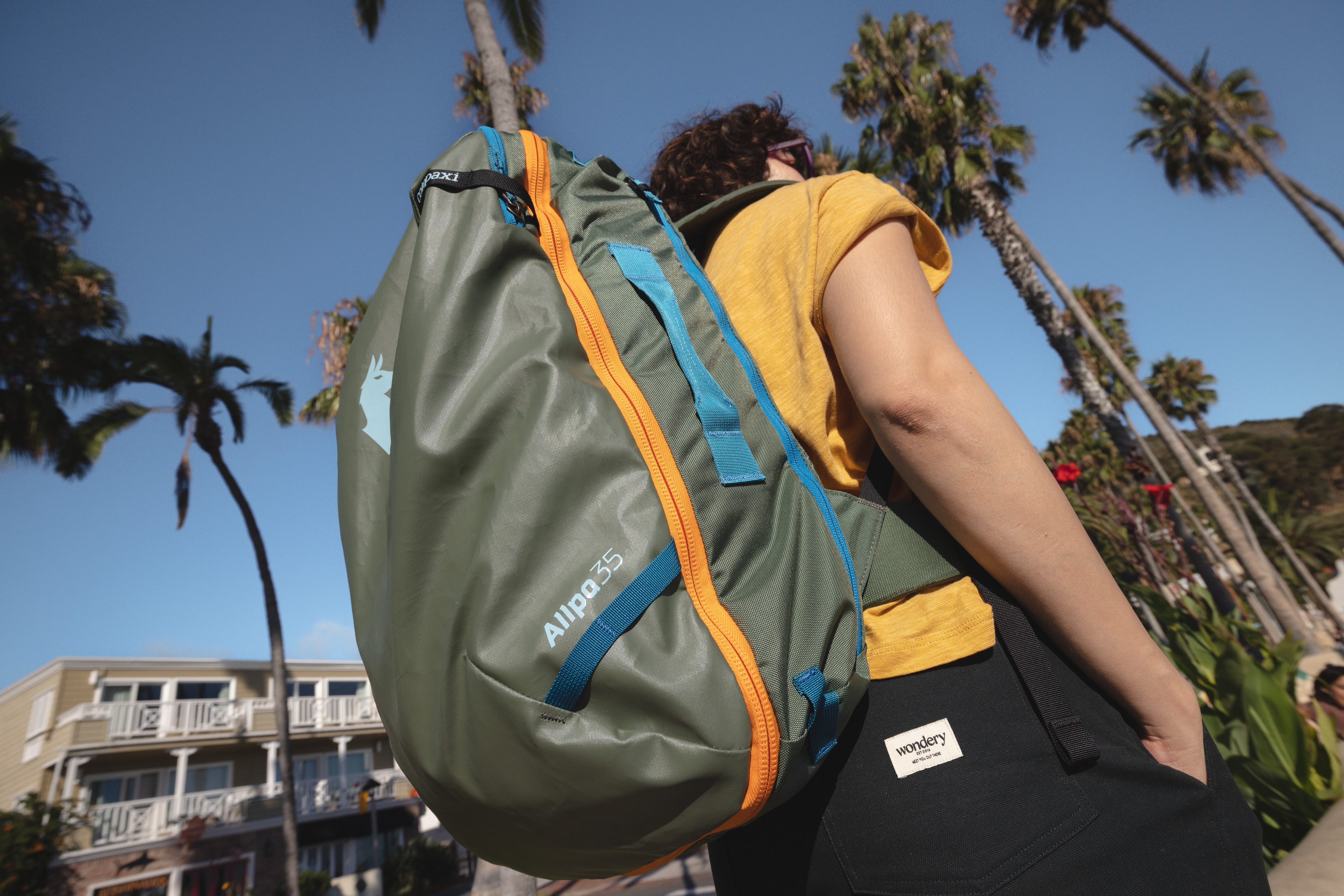 A person wearing a Cotopaxi backpack.