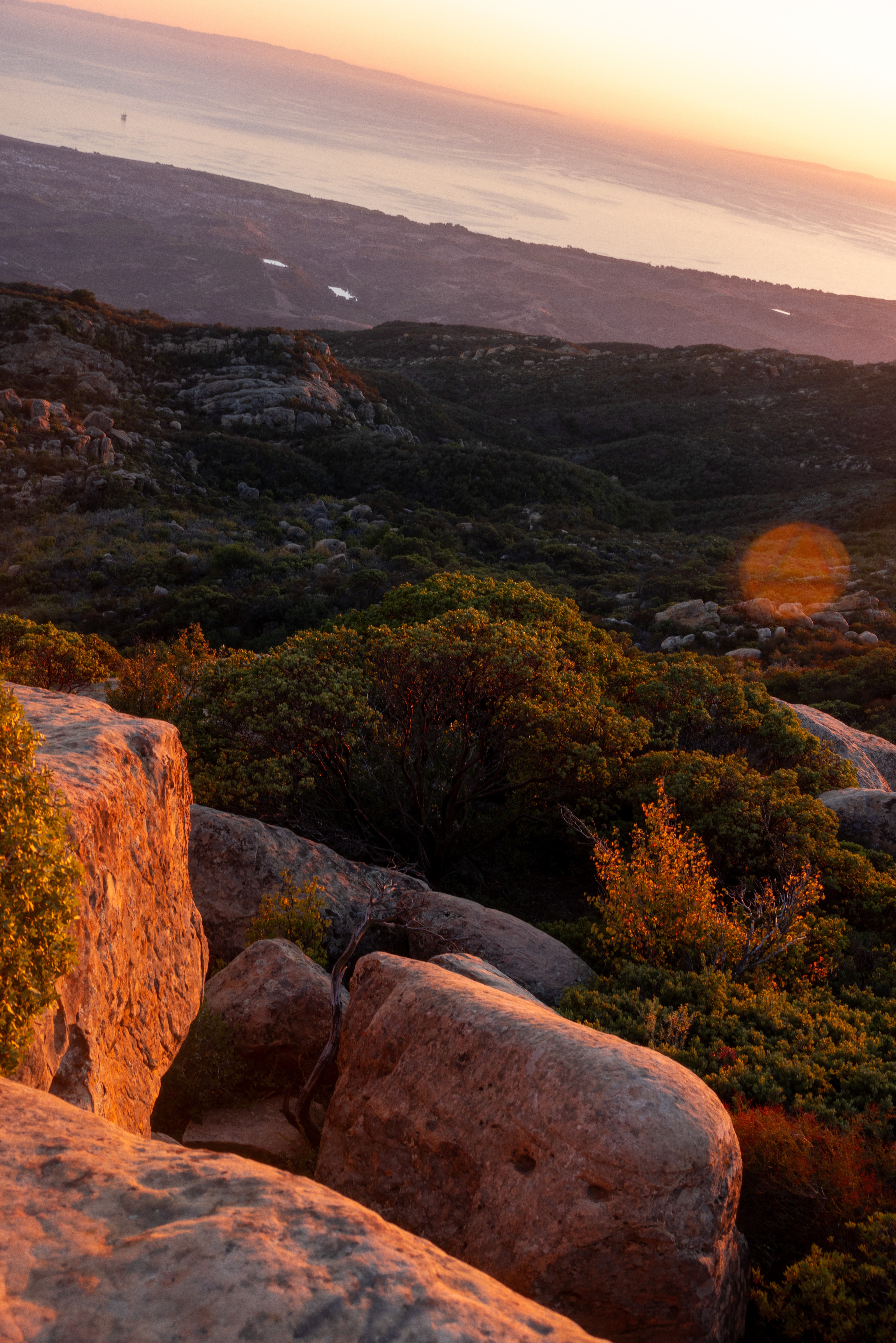 Large rocks and mountains at sunset.