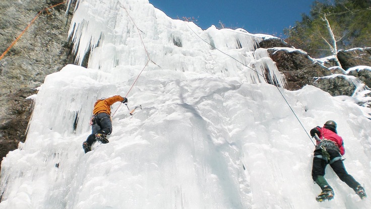 Two roped climbers on a frozen waterfall