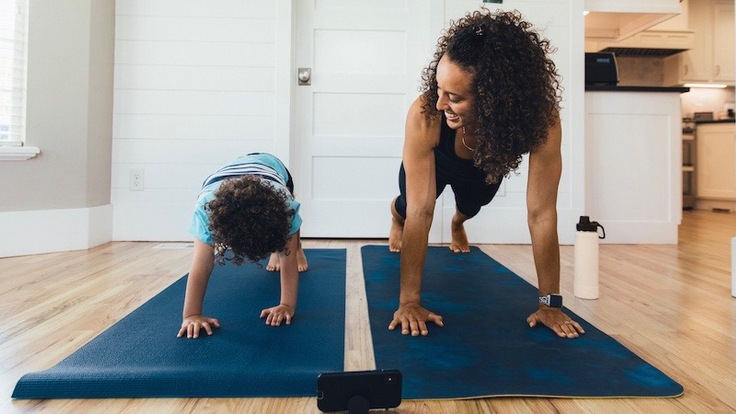 Mom and child doing a yoga pose.