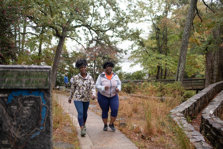 Two women walk the park