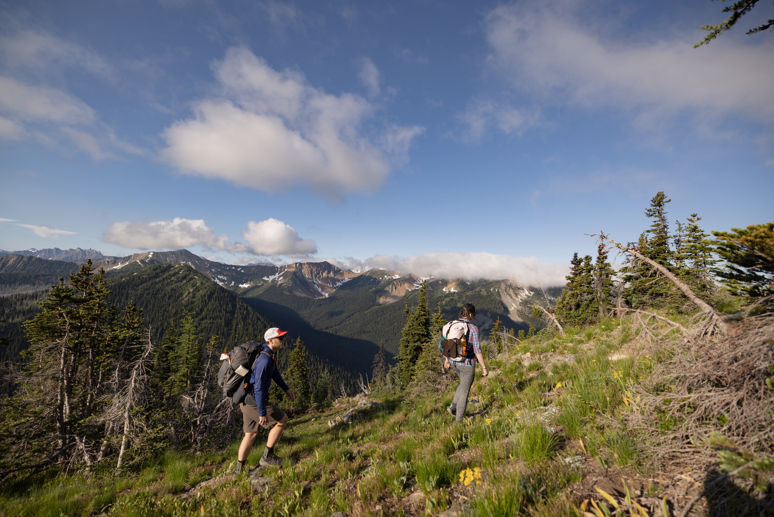 Two people hiking in a mountain landscape