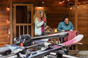 Ski racks in the foreground of a cabin scene
