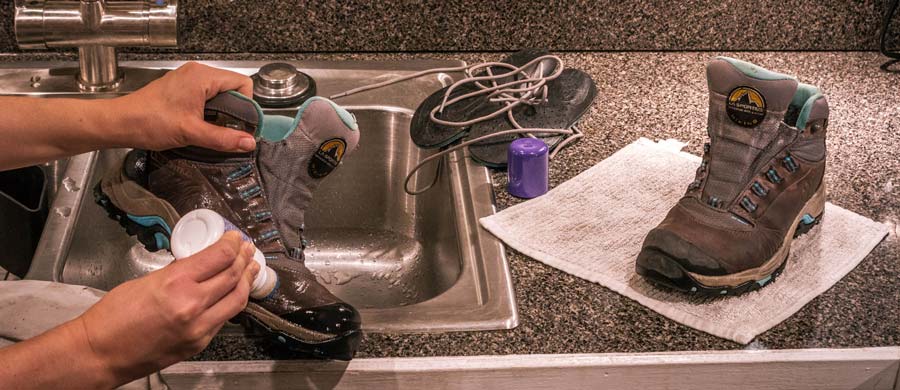 applying a waterproof treatment to hiking boots