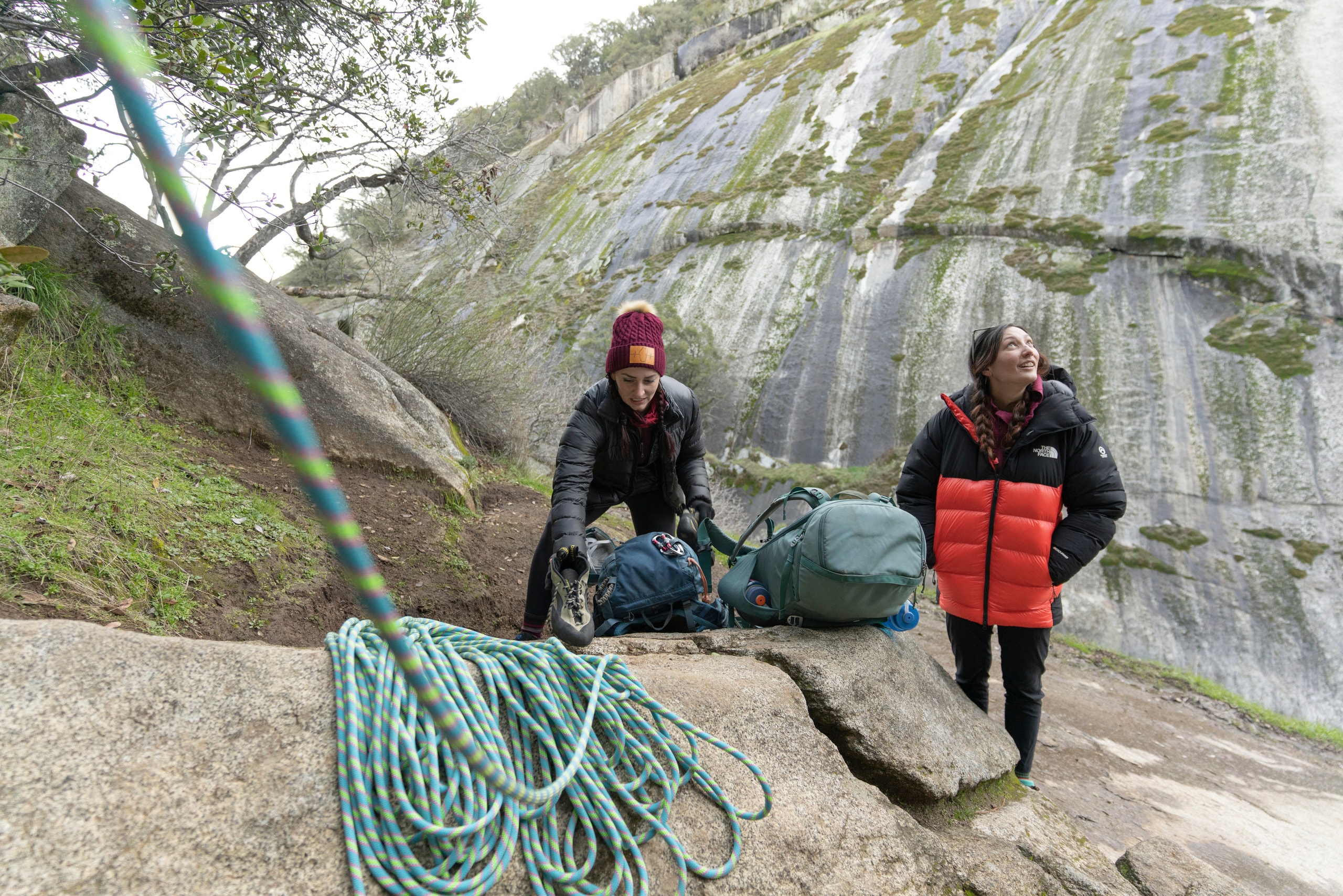 Two climbers set up a rope to get ready to climb