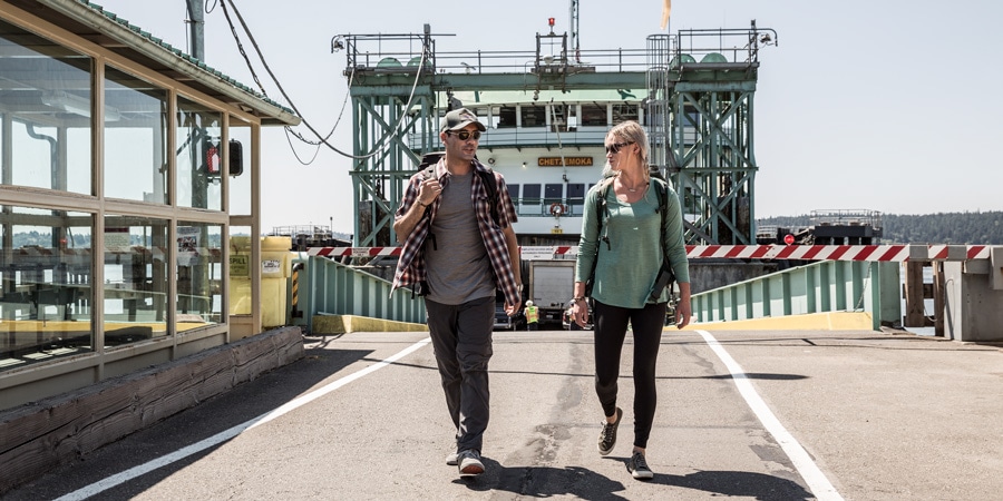 Two travelers walking off a ferry