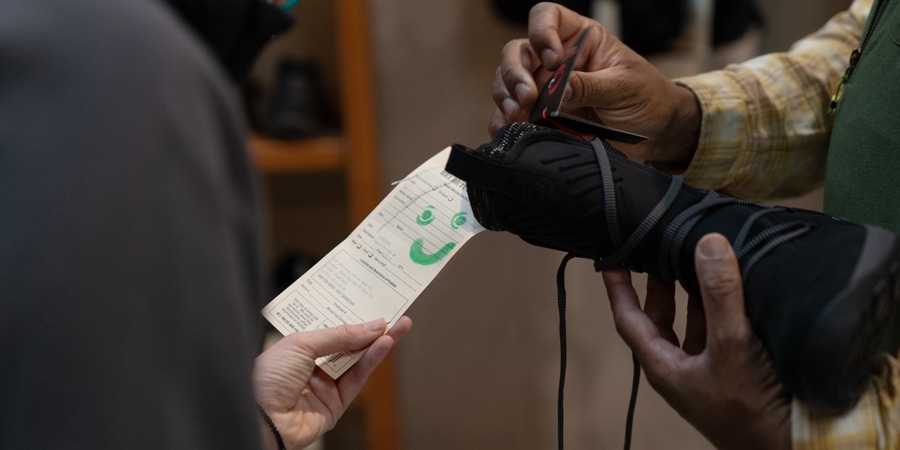 An REI customer inspects the tag on a piece of used gear at REI Co-op.