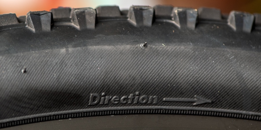 the rotation and tread direction marked on the sidewall of a bike tire